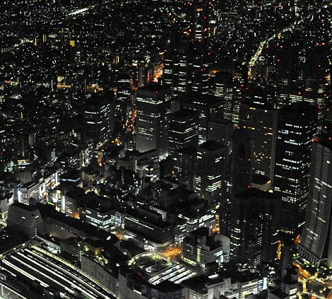 Dimmer: Buildings in Tokyo turn down the lights as part of electricity saving efforts to avoid massive power outages
