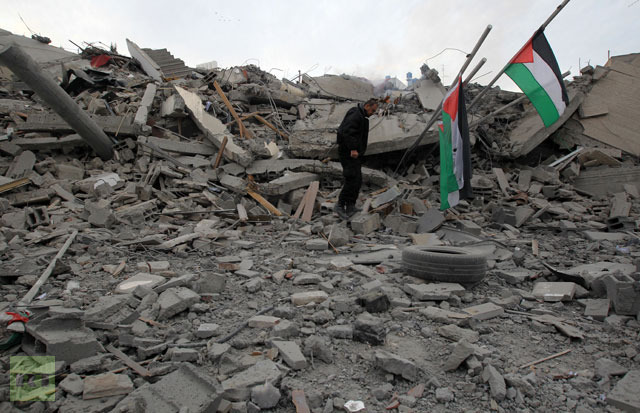 A Palestinian Hamas security member inspects the destroyed office building of Hamas Prime Minister Ismail Haniya in Gaza City on November 17, 2012.(AFP Photo / Mahmud Hams)