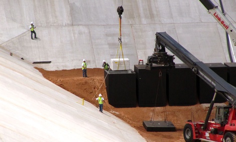 Commercial crews load the first of two containers with low-level radioactive waste from Los Alamos National Laboratory. Commercial crews load the first of two containers with low-level radioactive waste from Los Alamos National Laboratory.
